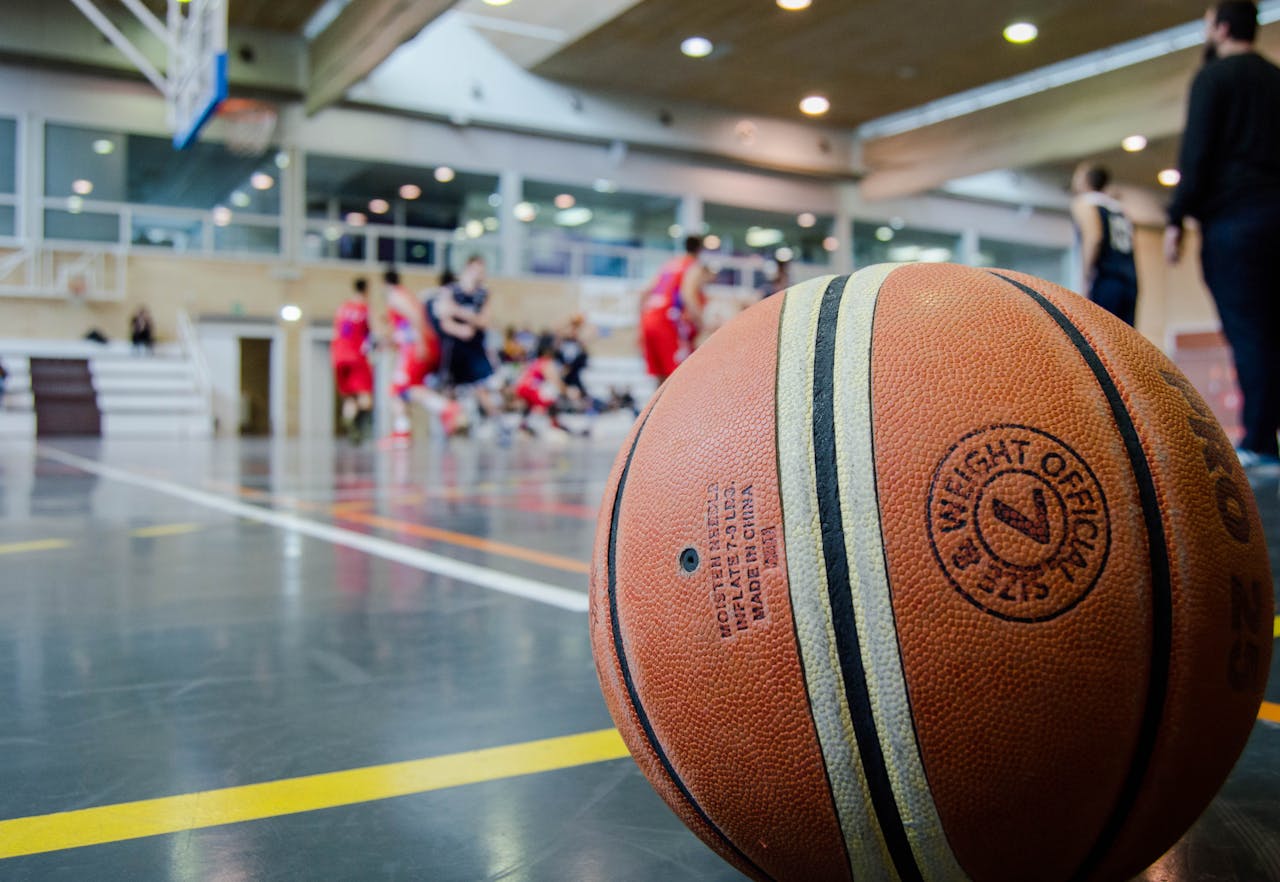 our-services-3 Captivating indoor basketball scene with players actively engaged in a game.